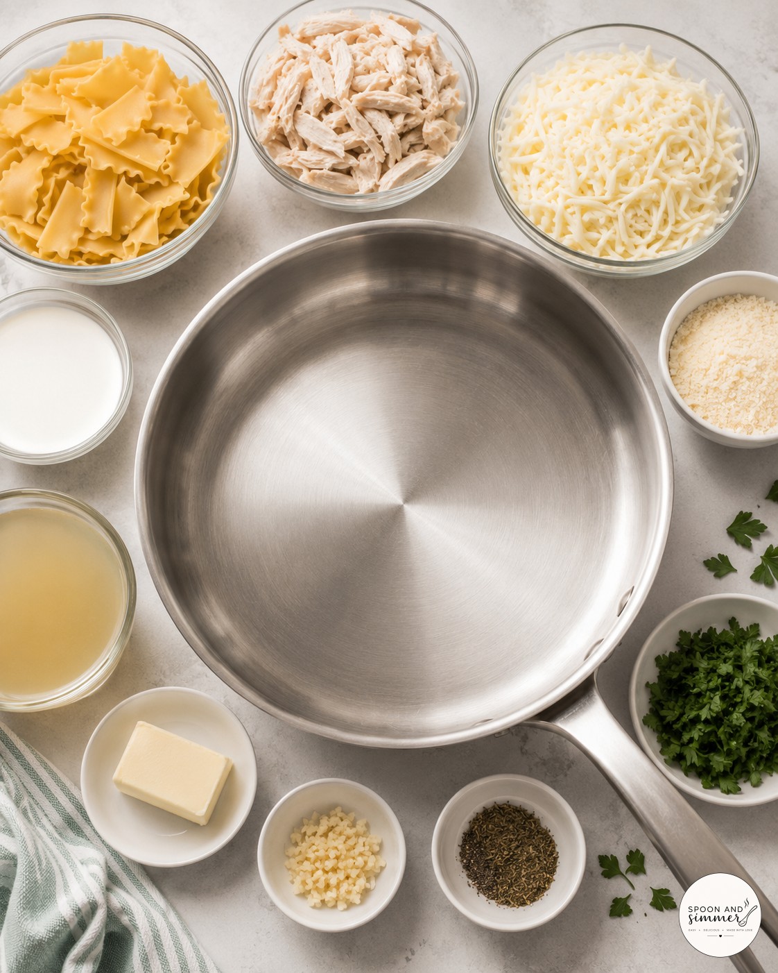 Ingredients laid out for white chicken skillet lasagna, including noodles, chicken, cream, and cheese
